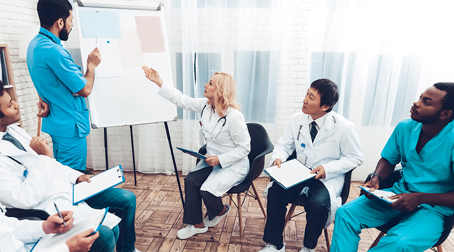 Doctors and Nurses Looking at a White Board